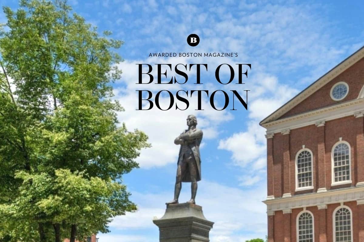 The Full Revolutionary Story: A Masterclass Boston Walking Tour The patriotic leader Sam Adams standing in front of "The Cradle of Liberty" Faneuil Hall.