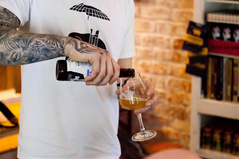 Versa la birra in un bicchiere da degustazione
