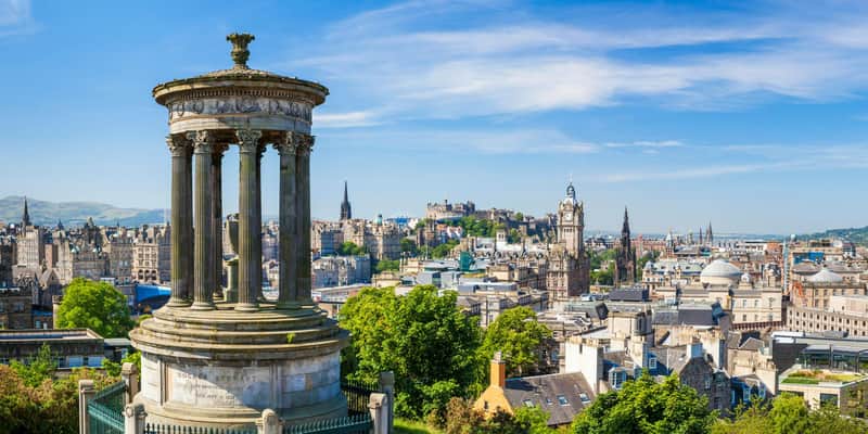 View of Edinburgh from Calton Hill, with the Dugald Stewart Monument in the foreground and Edinburgh Castle in the background.